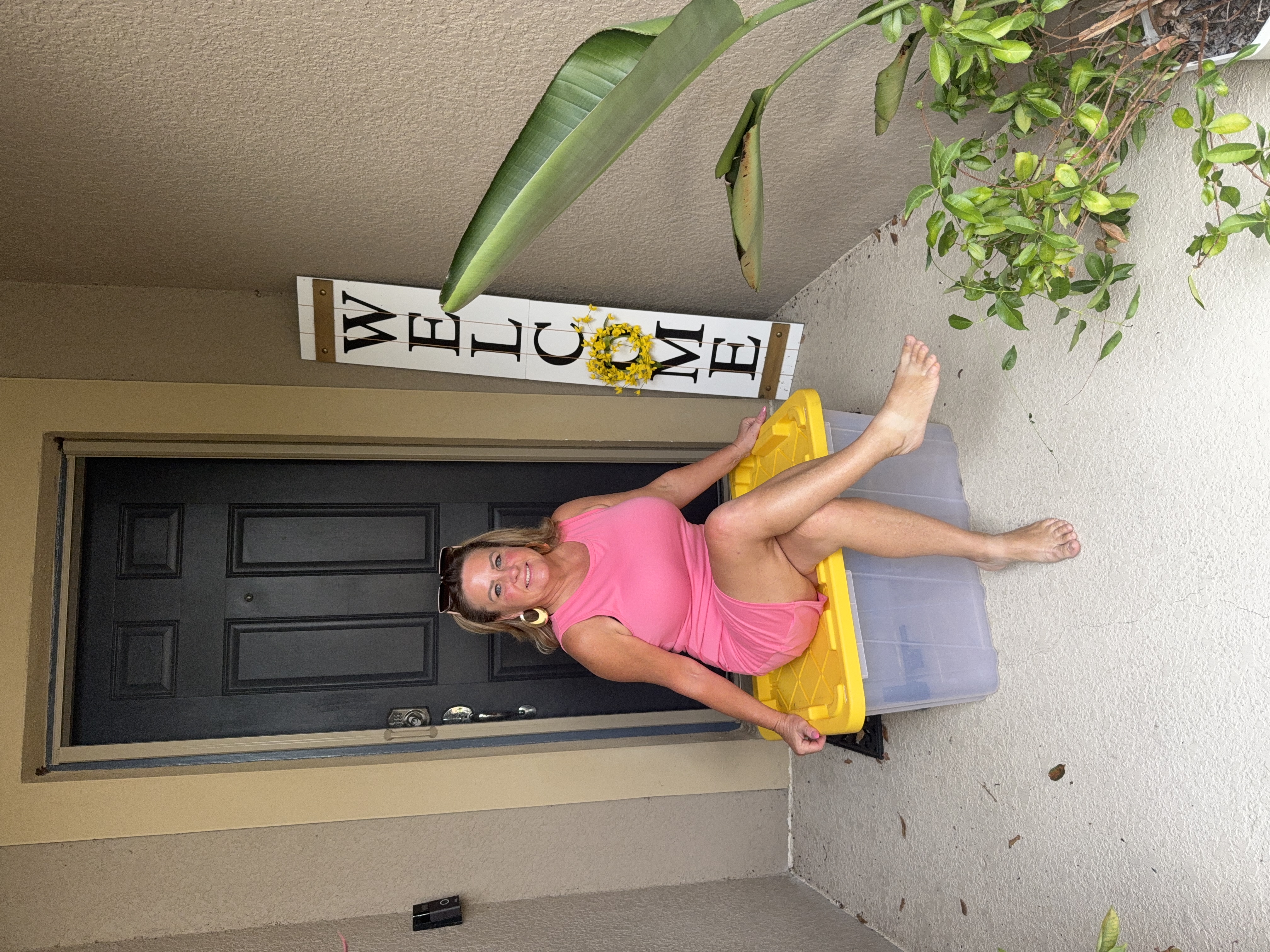 Donna sitting on a tote at your doorstep